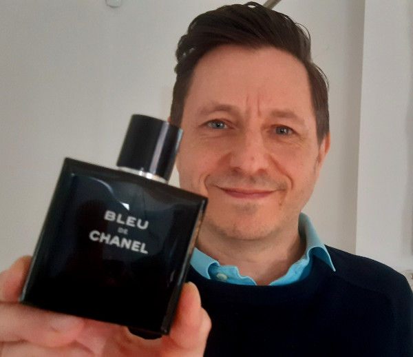 Andrew holding Bleu de Chanel Eau de Toilette