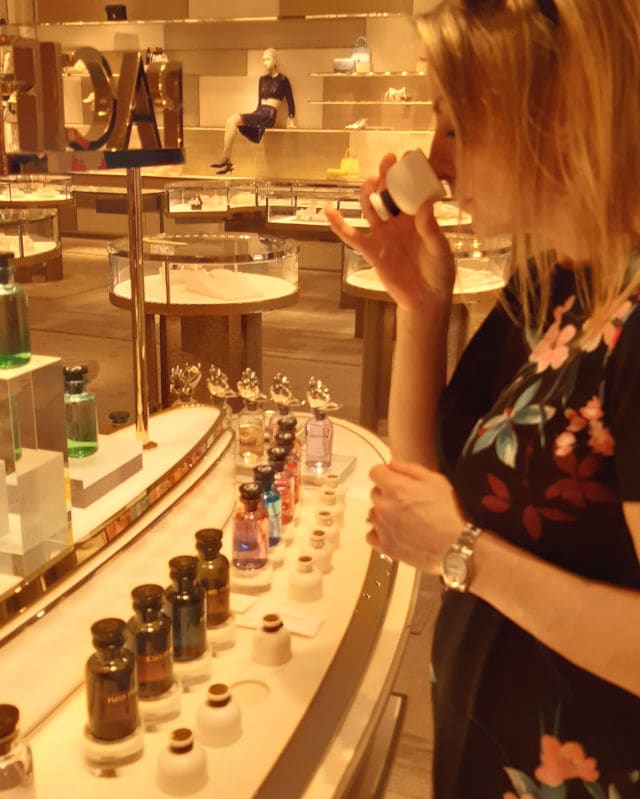 Ingrid smelling Louis Vuitton perfumes in-store