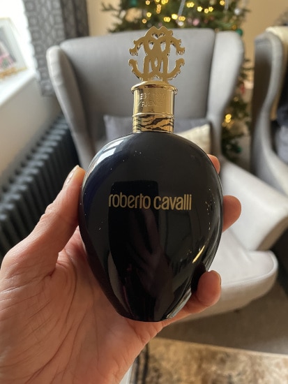 Ingrid holding a bottle of Roberto Cavalli Nero Assoluto Eau de Parfum
