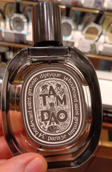 Andrew holding tester bottle of Diptyque Tam Dao Eau de Parfum