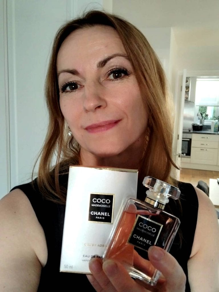 Ingrid Radford holding a bottle of Coco Mademoiselle Crush Absolu
